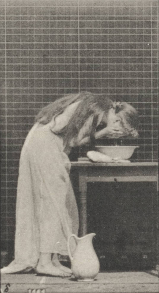 Woman_brushing_hair_and_washing_face_(rbm-QP301M8-1887-496a-8)